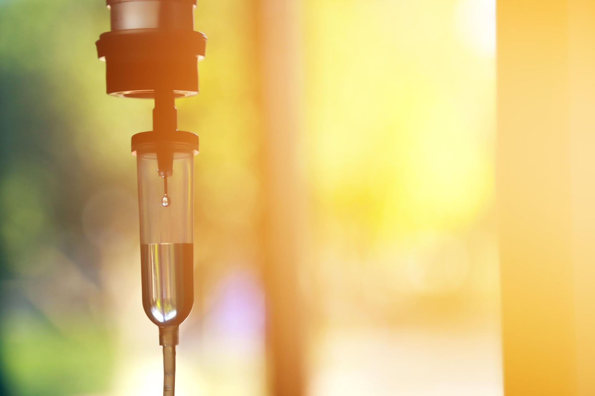 Saline iv bag intravenous drip hospital room,Medical Concept,treatment patient emergency and injection drug infusion care chemotherapy concept.blue light background hospital,Selective focus